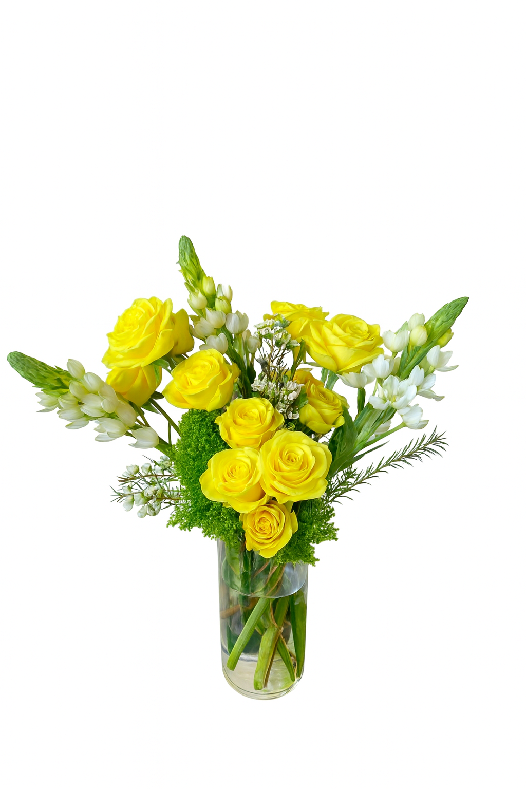 A cheerful and vibrant floral arrangement featuring bright yellow roses as the focal point, accented by creamy white bouvardia and lush greenery, including green dianthus. The flowers are arranged in a tall, clear glass cylinder vase, allowing the sturdy stems to show through. The overall design is upright and fresh, giving a sunny and uplifting feel.