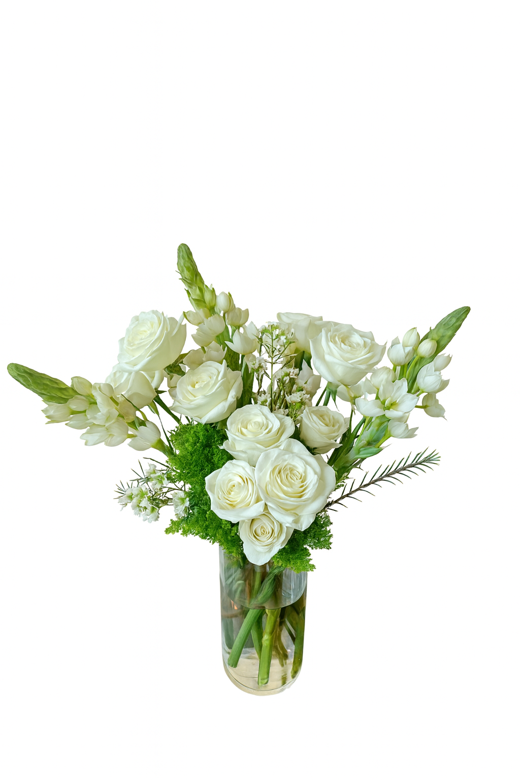 This elegant floral arrangement features an all-white theme displayed in a tall, clear glass cylinder vase. The bouquet is composed primarily of creamy white roses and lisianthus, accented with white snapdragons, delicate filler blooms, and lush green foliage. The white-on-green contrast brings a timeless, peaceful, and graceful aesthetic, perfect for a minimal and sophisticated presentation.