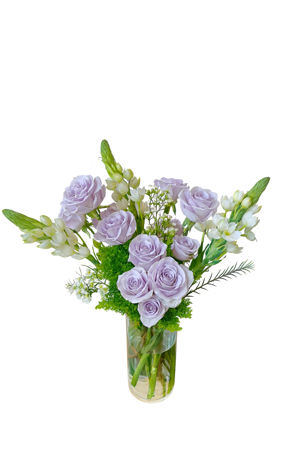 This elegant floral arrangement features delicate lavender roses paired with creamy white lisianthus and soft white snapdragons. Set in a tall, clear cylindrical glass vase, the bouquet is accented with lush green mossy fillers and sprigs of airy white limonium. The vertical orientation of the snapdragons and the pastel color palette create a graceful and serene aesthetic perfect for refined occasions.