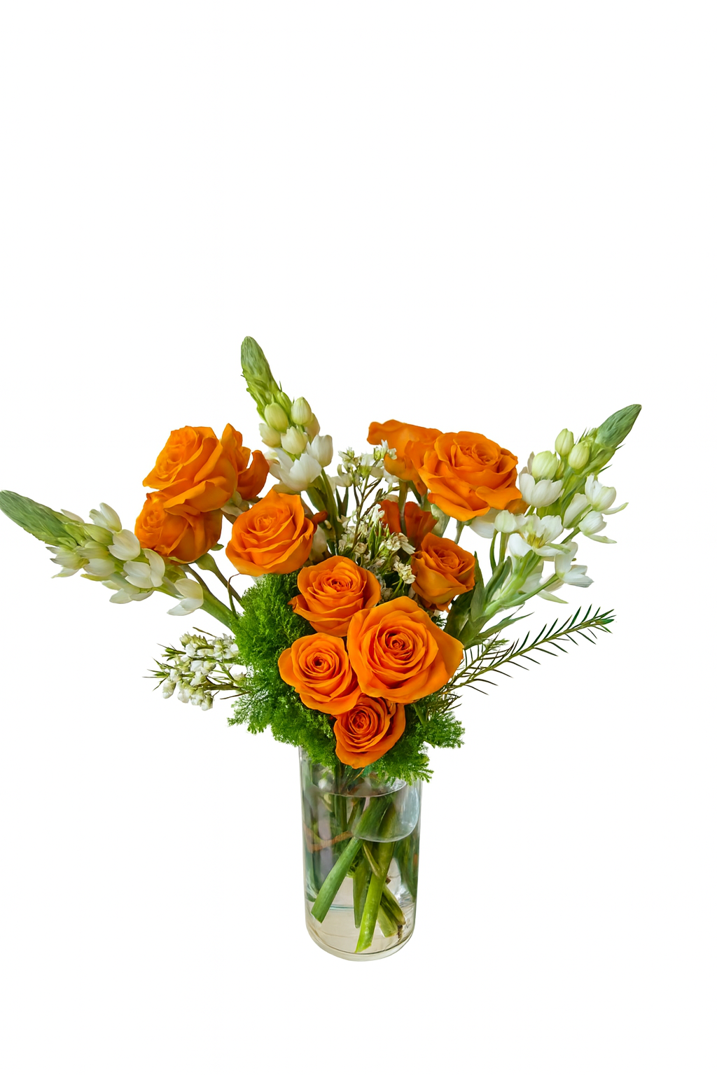 A tall and elegant cylindrical glass vase showcases a stunning arrangement of vibrant orange roses paired with crisp white bouvardia. The bouquet is complemented by touches of green moss filler and delicate white accent flowers. This vertical arrangement radiates brightness and joy, making it a beautiful focal piece for any celebration.