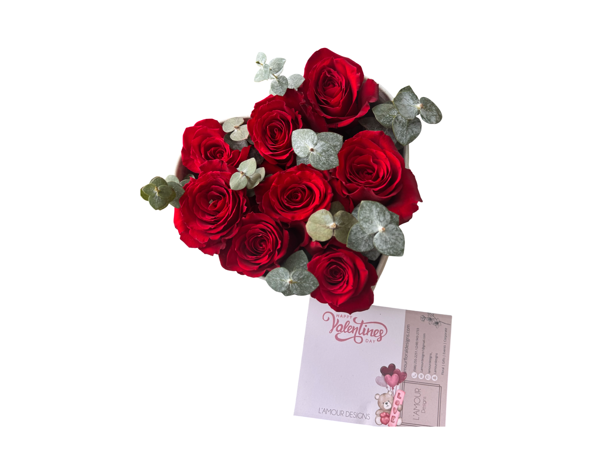 A charming heart-shaped arrangement of red roses and eucalyptus greenery in a compact box, accompanied by a "Happy Valentine’s Day" card from L’amour Designs. This simple yet meaningful design is a sweet gift for romantic occasions and holiday celebrations.