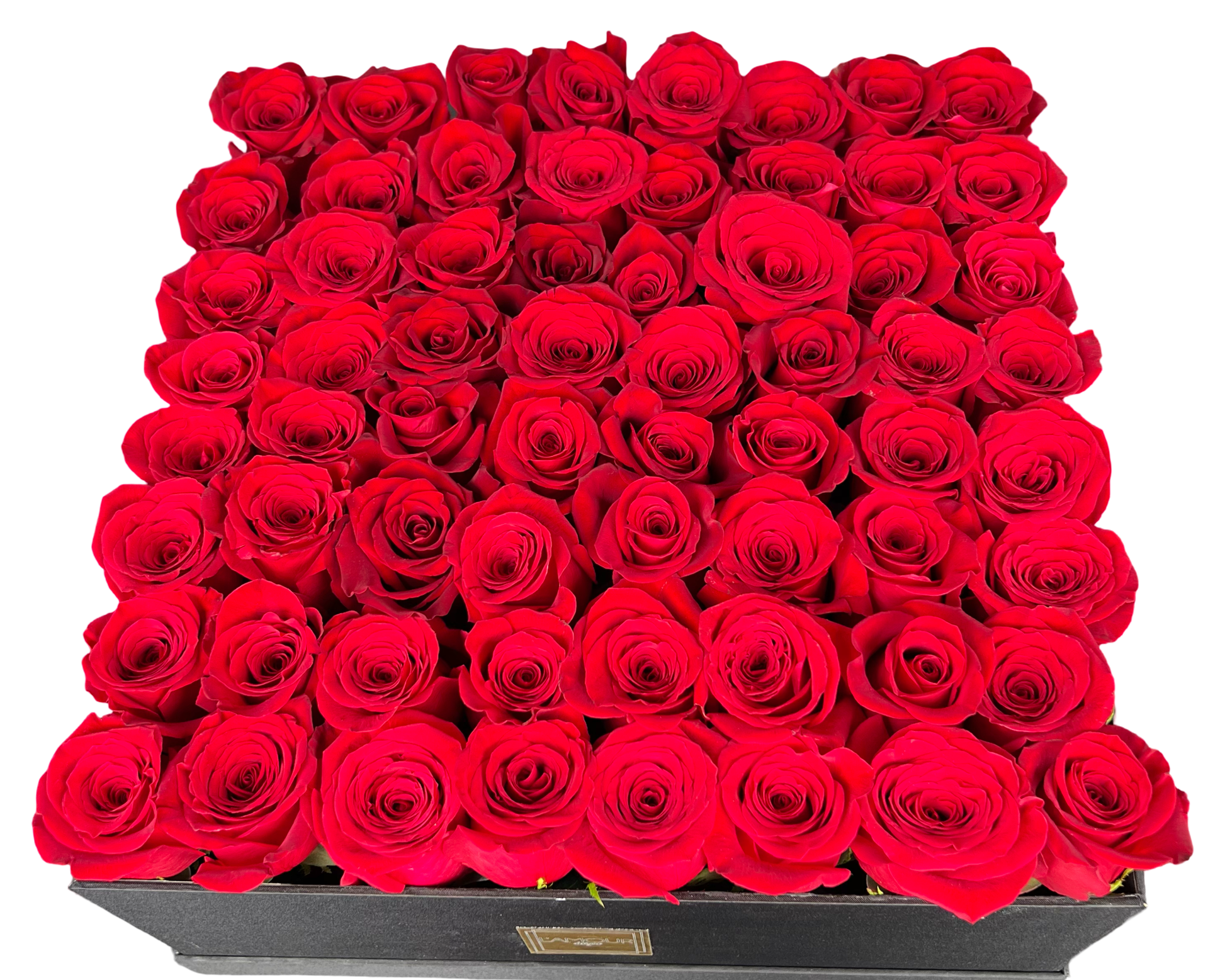This arrangement features a perfectly symmetrical square luxury hatbox filled with dozens of rich, velvety red roses. Each rose is meticulously arranged in a tight, uniform grid, creating a dramatic, opulent presentation. The deep red hue evokes passion and romance, making this floral design a showstopping gift for celebratory and sentimental occasions alike.