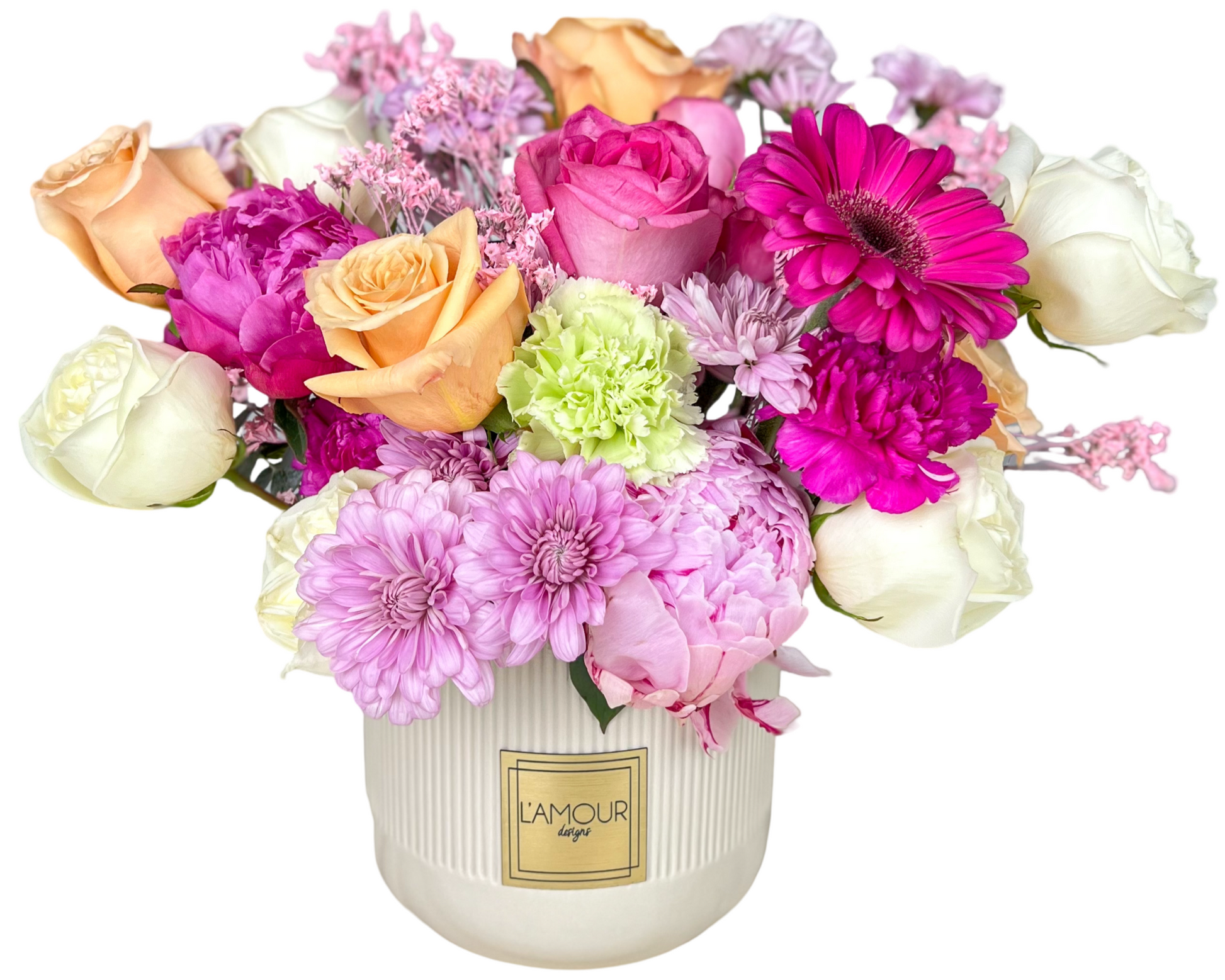A joyful and colorful floral arrangement featuring a harmonious blend of white roses, peach roses, pink roses, and vibrant hot pink gerbera daisies. Soft green carnations, lush pink peonies, and lavender chrysanthemums add depth and texture, while sprigs of delicate filler flowers complete the design. Presented in a sleek white L'amour Floral Designs vase, this arrangement is perfect for brightening any space and celebrating special occasions like birthdays, anniversaries, and Mother’s Day.