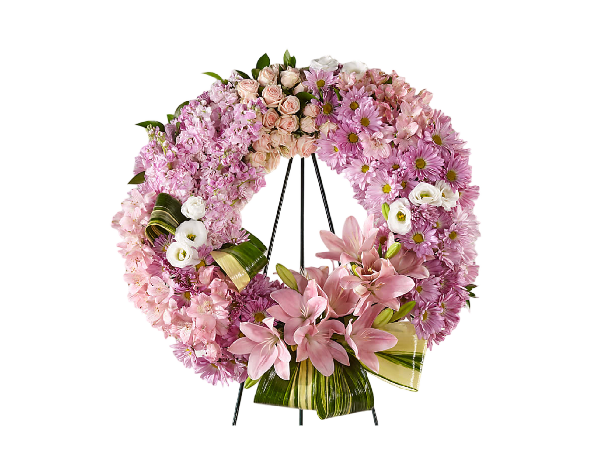 A stunning sympathy standing wreath on a black easel, composed of pink lilies, blush spray roses, lavender chrysanthemums, pink hydrangeas, lisianthus, and accented with bold variegated ti leaves and tropical greenery. This full-circle floral tribute expresses heartfelt remembrance and serenity, ideal for funerals or memorial services.