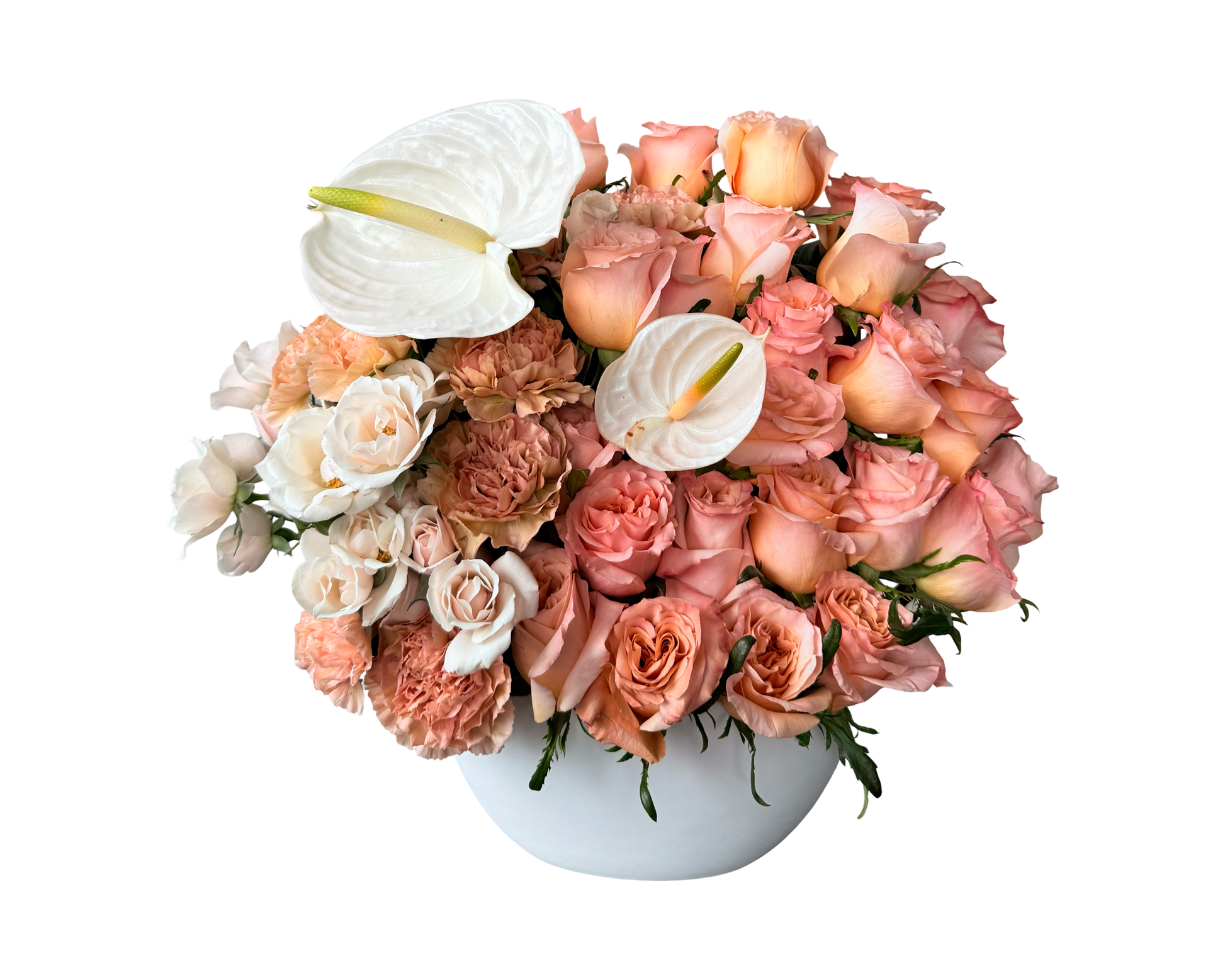 A modern and elegant floral arrangement presented in a white ceramic bowl, featuring a lush blend of peach roses, apricot spray roses, beige carnations, creamy white lisianthus, and two white anthuriums as sculptural accents. This warm-toned bouquet offers a refined, designer look—ideal for stylish gifting, upscale décor, or meaningful celebrations.