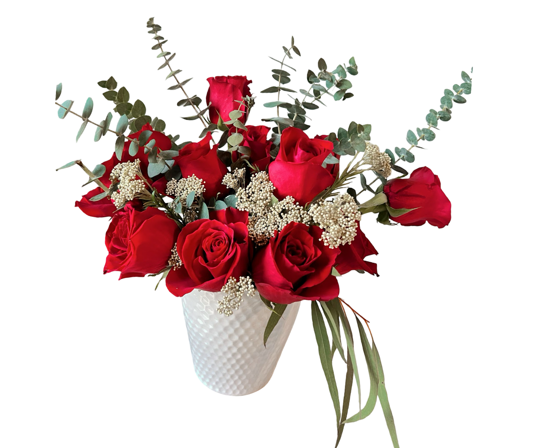 A timeless arrangement of red roses in a white textured ceramic vase, accented with silver dollar eucalyptus and white yarrow filler. The rich red blooms and soft greenery create a bold yet elegant display—perfect for romantic gestures, anniversaries, and sophisticated celebrations.
