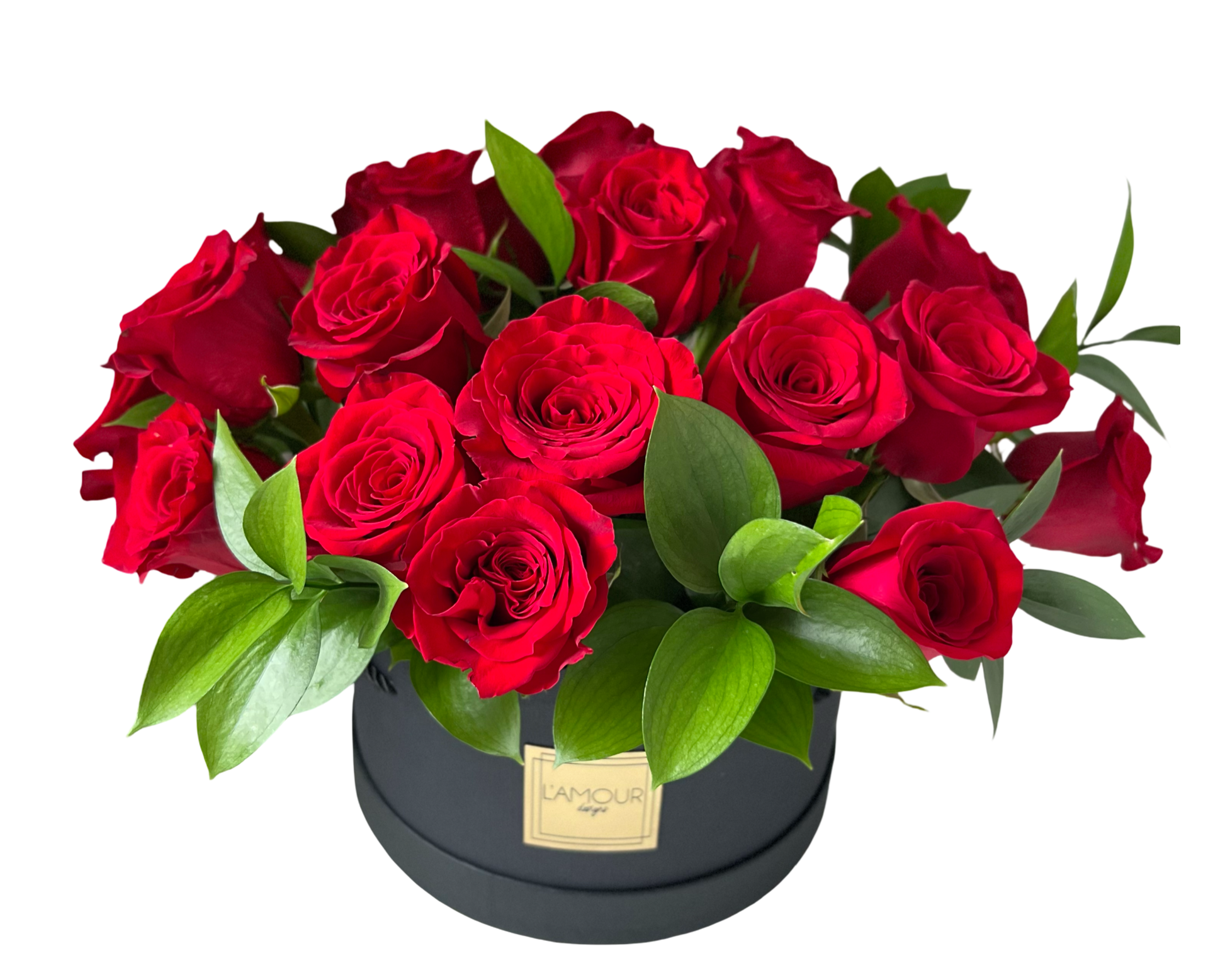 A luxurious and classic floral arrangement featuring deep red roses with lush green foliage, carefully arranged in a matte black round hatbox from L’amour Designs. The bold red and black contrast creates a sleek, romantic presentation—ideal for upscale gifting, romantic celebrations, or elegant statements.